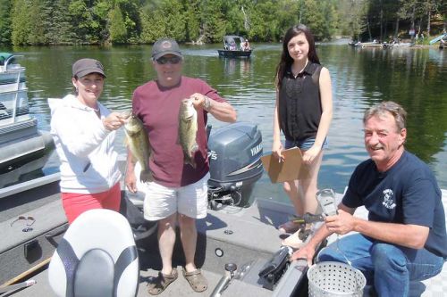 Robin Soluri and Ron Skevington weigh in with Kate Osborne and Denis Bedard at the Palmerston Lake Bass Derby that took place at the Double S Marina in Ompah on June 21 & 22.